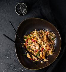 Fried noodles with chicken and vegetables. chicken chow mein.