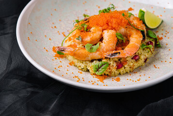 Couscous with vegetables and shrimp under red caviar