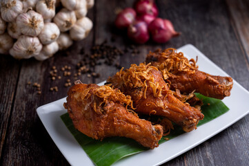 Deep fried chicken and fried onions, southern style herbs recipe on wooden table.