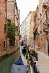 Venice canal between colorful facades and with gondolas