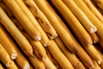 Thin and long bread sticks made of wheat flour on the table