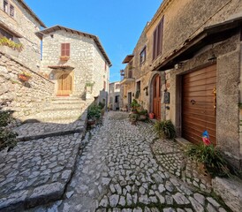 A narrow street among the old houses of Fumone, a historic town in the state of Lazio in Italy.