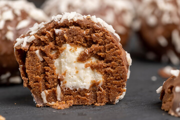 Chocolate candies in the form of balls with milk coconut