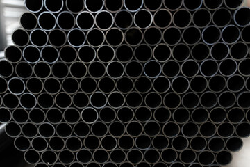 Stack of steel pipes. Close - up of stack of metal pipes. Industrial elements closeup. Parts...