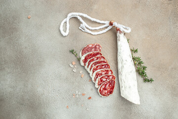 Slices of delicious spanish sausage fuet on a light background. banner, menu, recipe place for text, top view © Надія Коваль