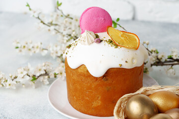 Easter cake and golden eggs on table