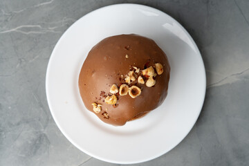 Ester cake with chocolate topping and nuts on gray background