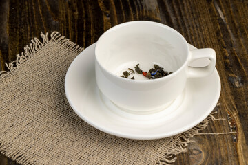 Not cooked green tea in a white porcelain cup