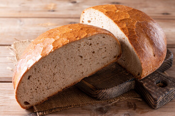 Fresh and tasty bread on a board. Bakery products.