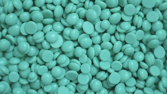 Wax granules for depilation. Background wax texture. Epilation, depilation, removal of unwanted hair. Rotation. View from above. Slow motion video. High quality 4k footage
