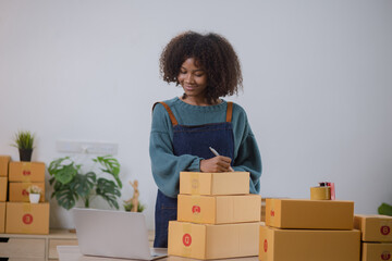 Young African American woman and online selling at home office, Startup small business owner working Online selling and product order for delivery to customer.