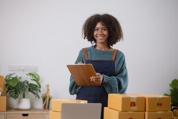 Young African American woman and online selling at home office, Startup small business owner working Online selling and product order for delivery to customer.