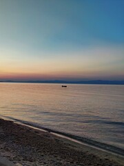 Sunset on the beach - seaside vacation  - pink waters at sunset