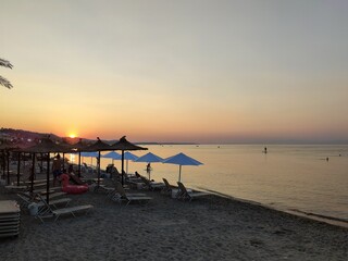 Sunset on the beach - seaside vacation  - pink waters at sunset