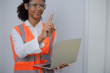 Engineering African American businesswoman holding digital tablet and computer in hands. African American woman builder using touchpad,  Constuction,