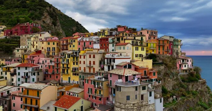 Sunset aerial view of Manarola Cinque Terre Italy Liguria famous historic town of colorful houses on the cliffs of Mediterranean Sea Drone view