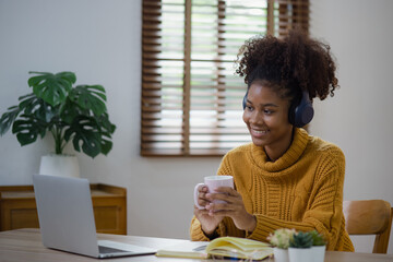 Young African American businesswoman studying or working at home.