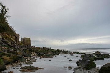what lays behind Mont Saint Michel in Normandy, France