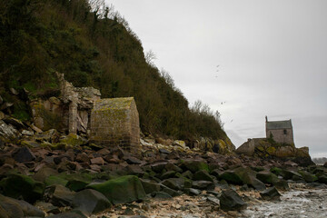 what lies behind Mont Saint Michel in Normandy, France