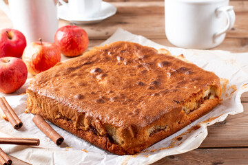 Clasic sponge cake with apples on table, selective focus. Homemade cake
