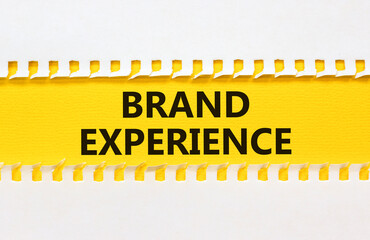 Brand experience symbol. Concept words Brand experience on yellow paper. Beautiful yellow table...