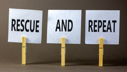 Rescue and repeat symbol. Concept words Rescue and repeat on white paper on wooden clothespin on a beautiful grey table grey background. Business rescue and repeat concept. Copy space.