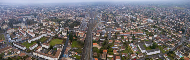 Fototapeta na wymiar Aerial around the city Ambérieu-en-Bugey in France on a cloudy afternoon in late winter.