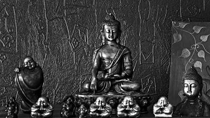 Traditional bronze Buddha statue isolated on black background. © chere