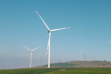 Wind turbine and windmill. Clean energy in green nature in different locations. Sustainability and environment concept
