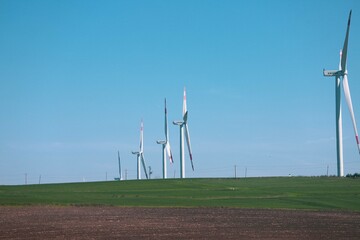 Wind turbine and windmill. Clean energy in green nature in different locations. Sustainability and...