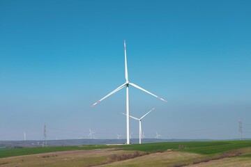 Wind turbine and windmill. Clean energy in green nature in different locations. Sustainability and...