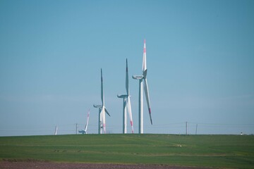 Wind turbine and windmill. Clean energy in green nature in different locations. Sustainability and...