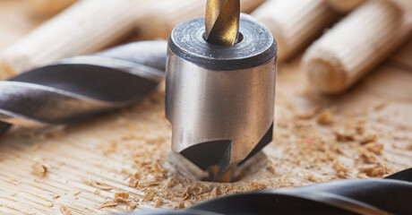 Countersink drill bit with steel triangle ruler make sink in hole for screw in wooden oak plank