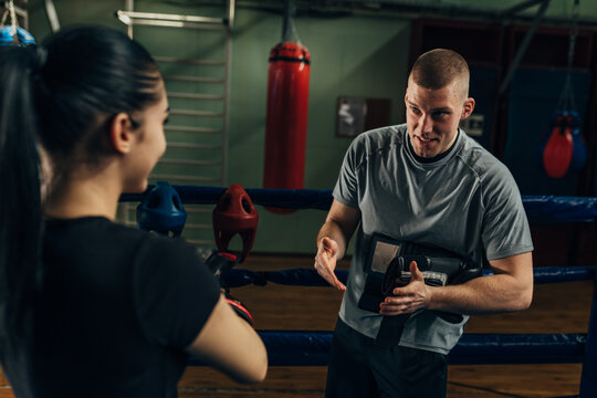 A coach is giving instruction to a sportswoman before training - Powered by Adobe