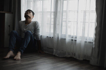 Sad young man sitting in the bedroom, People with depression concept, stressed man,	