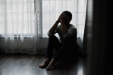 Sad young man in the bedroom, People with depression concept.	