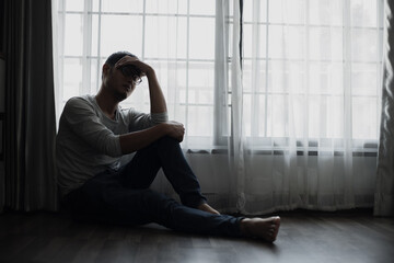 Sad young man in the bedroom, People with depression concept.	