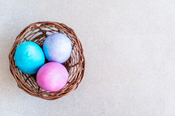 Easter eggs with copy space for text, Colourful Easter eggs in a basket, 2023 Easter concept background