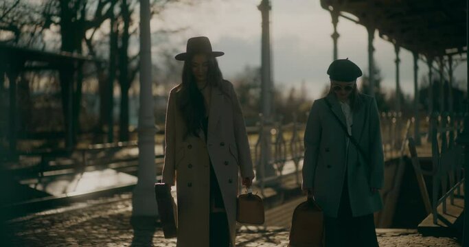 Two Women Talking at Railway Station