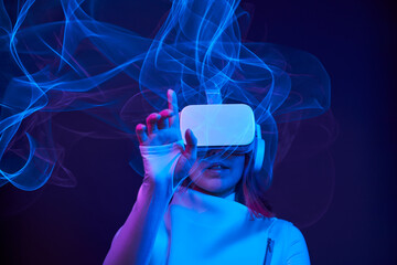 Woman is using virtual reality headset to access in metaverse.