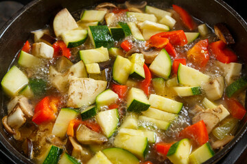 Frying pan with vegetables cut for stewing in sauce and spices.