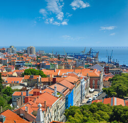 Fototapeta na wymiar Sea port with cranes view and cityscape from Monastery roof in Lisbon, Portugal.