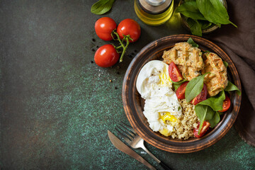 Keto diet. Delicious breakfast or brunch - zucchini vegan waffles, poached egg, quinoa and fresh vegetable salad on a stone tabletop. View from above. Copy space.