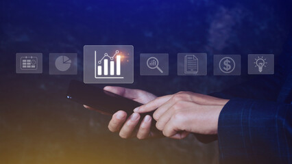 Data analytics and business intelligence BI concept with chart and graph icons on digital screen interface on smartphone and business people in the background.