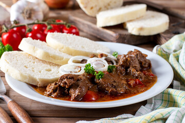Homemade hot Czech goulash with knodel in a plate close-up. horizontal - obrazy, fototapety, plakaty