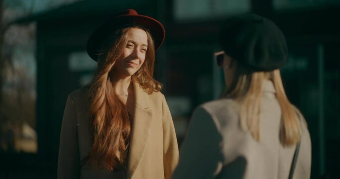 Two Women Talking at Railway Station