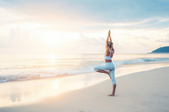 Yoga outdoors, fit woman doing Hatha yoga on tropical beach on sunset Generative AI