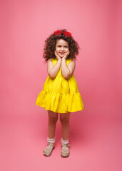 portrait of a girl in a yellow dress cute attractive cute cheerful cheerful little girl .isolated pink background.