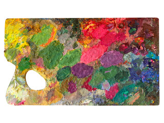 Wooden palette for oil paints with paint  isolated on white background. Bright, stained with colors, a real palette of the artist. Top view.