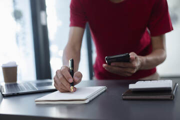 businessmen use calculator and smartphone with financial at desk in office.